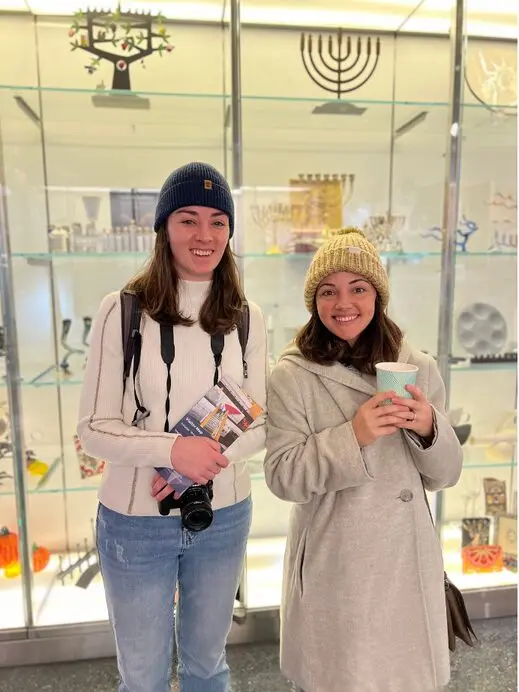 Two women dressed for winter inside Museum Store