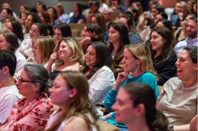 Audience Members Seated in theater enjoying program